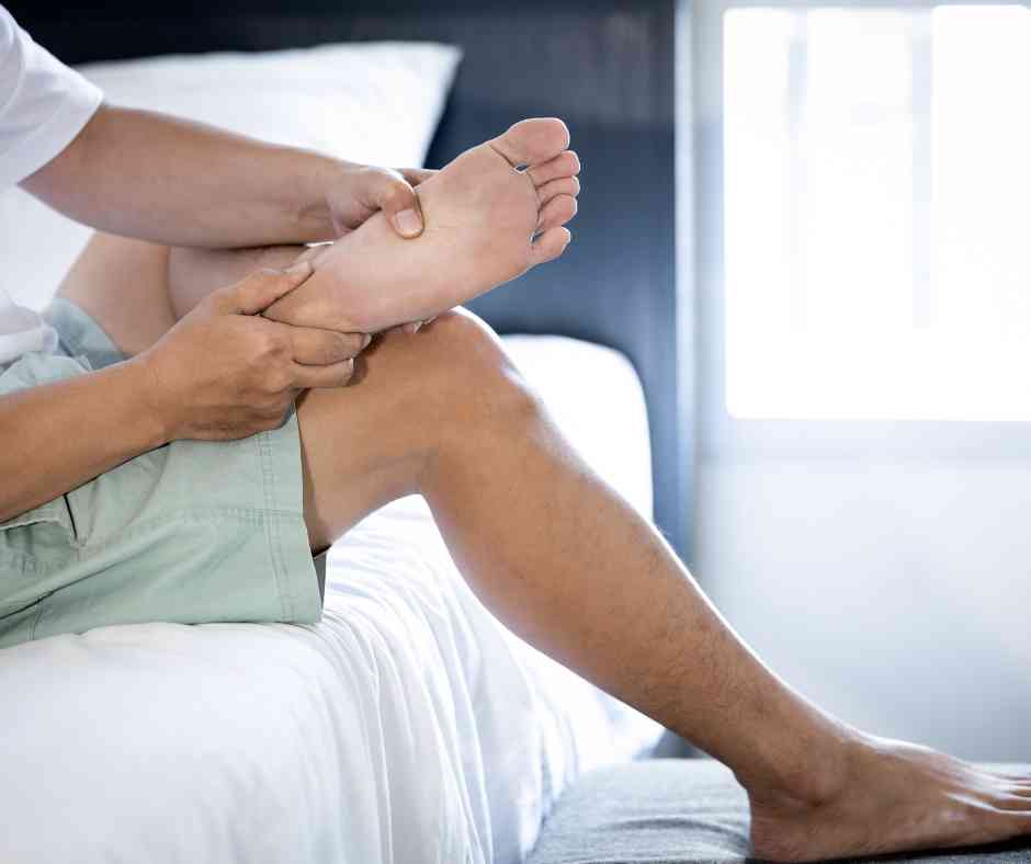 massaging foot to help loosen fascia